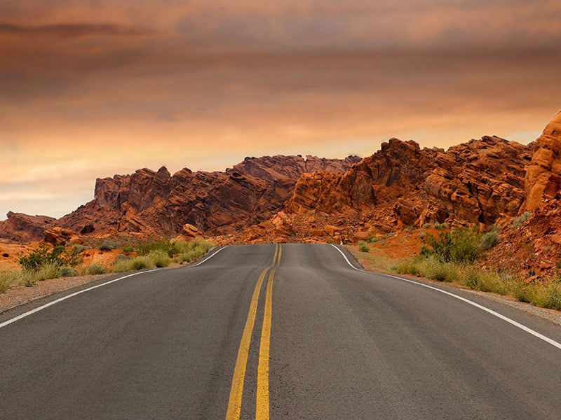 Open highway through red rock formations